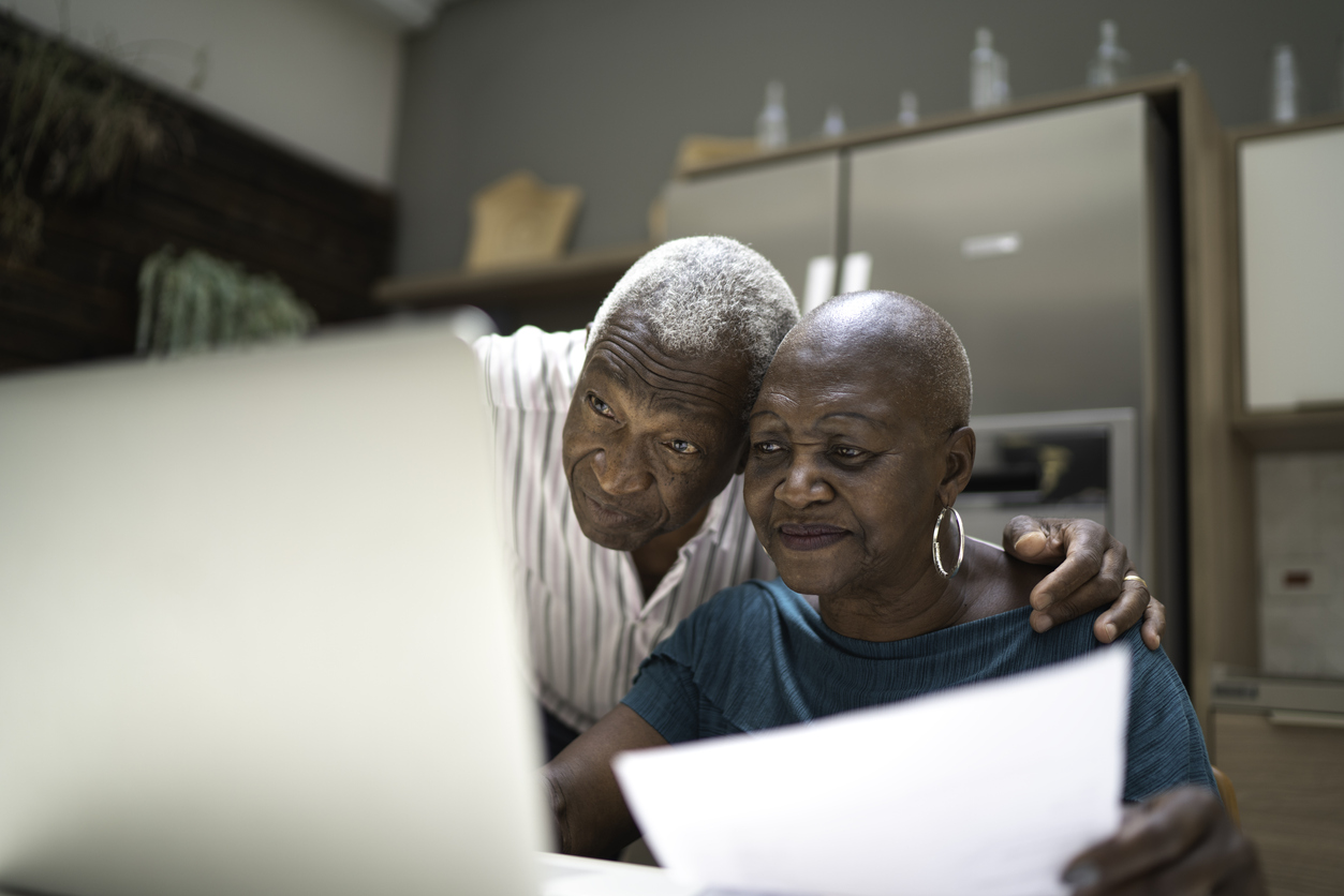 photo of a older couple using a laptop computer